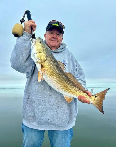 Smiling angler with a big redfish